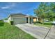 Inviting one-story home with a neutral color palette, two-car garage, and a well-kept front yard at 264 Milestone Dr, Haines City, FL 33844