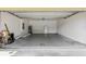 Spacious garage featuring a durable concrete floor provides ample room for parking and storage at 264 Milestone Dr, Haines City, FL 33844