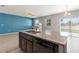 Kitchen island featuring granite countertop, stainless steel sink, and open-concept design at 264 Milestone Dr, Haines City, FL 33844