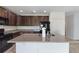 Gourmet kitchen with granite counters, dark cabinets, and stainless steel appliances at 264 Milestone Dr, Haines City, FL 33844
