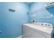 Functional laundry room with a modern washer and dryer, plus shelving for optimal organization at 264 Milestone Dr, Haines City, FL 33844