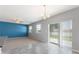 Open living area showcasing modern flooring, neutral walls, and sliding glass door to yard at 264 Milestone Dr, Haines City, FL 33844