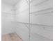 Walk-in closet with metal shelving and wood-look floors offers ample storage space at 264 Milestone Dr, Haines City, FL 33844