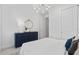Bright bedroom features neutral walls, large closet doors, and modern chandelier for a serene retreat at 2674 Midsweet Ave, St Cloud, FL 34772