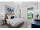 Bright bedroom features neutral walls, large windows, and modern chandelier for a serene retreat at 2674 Midsweet Ave, St Cloud, FL 34772