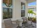 Cozy front porch with comfortable seating, charming table, and well-manicured landscaping at 2674 Midsweet Ave, St Cloud, FL 34772