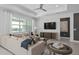 Cozy living room with a sectional sofa, large windows offering lake views, and modern furnishings at 2674 Midsweet Ave, St Cloud, FL 34772
