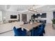 Open-concept living space featuring a modern kitchen with navy cabinets, dining area, and comfortable living room at 2674 Midsweet Ave, St Cloud, FL 34772