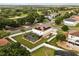 Enjoy aerial views of this home with an in-ground pool, screened-in enclosure, solar panels, and fenced-in yard at 2725 White Magnolia Loop, Clermont, FL 34711