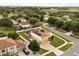 Enjoy aerial views of this home with an in-ground pool, screened-in enclosure, solar panels, and fenced-in yard at 2725 White Magnolia Loop, Clermont, FL 34711