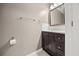 Half bath with a dark vanity and a mirror with white tile backsplash at 2725 White Magnolia Loop, Clermont, FL 34711