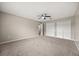 Spacious carpeted bedroom with a ceiling fan and double closets for ample storage at 2725 White Magnolia Loop, Clermont, FL 34711