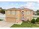 Two-story home with two-car garage, solar panels and landscaped front yard at 2725 White Magnolia Loop, Clermont, FL 34711