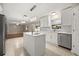 Modern kitchen featuring a center island, white cabinets, stainless appliances and stylish lighting at 2725 White Magnolia Loop, Clermont, FL 34711