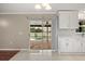 Bright kitchen featuring white cabinets, neutral countertops, and sliding doors opening to a pool area at 2725 White Magnolia Loop, Clermont, FL 34711
