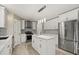 Modern kitchen with white cabinets, stainless appliances, an island and stylish lighting at 2725 White Magnolia Loop, Clermont, FL 34711