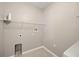 A simple laundry room with wire shelving and hookups at 2725 White Magnolia Loop, Clermont, FL 34711