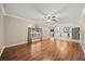 Living room with hardwood floors that flows into kitchen with white cabinets at 2725 White Magnolia Loop, Clermont, FL 34711