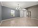 Bright, open living room showcasing tile floors, crown molding and a decorative chandelier at 2725 White Magnolia Loop, Clermont, FL 34711