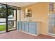This screened-in outdoor kitchen features a sink, stone countertops, and plenty of cabinet space for outdoor entertaining at 2725 White Magnolia Loop, Clermont, FL 34711