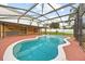 Enjoy a screened-in pool area with an outdoor kitchen and plenty of space for entertaining and relaxing at 2725 White Magnolia Loop, Clermont, FL 34711