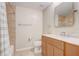 A bathroom featuring a vanity with double sinks and a shower with neutral tile at 2763 Metro Sevilla Dr # 103, Orlando, FL 32835