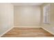 Bright bedroom featuring hardwood floors and a window providing natural light at 2763 Metro Sevilla Dr # 103, Orlando, FL 32835