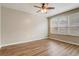 Bright bedroom features wood floors, neutral paint, and a ceiling fan at 2763 Metro Sevilla Dr # 103, Orlando, FL 32835
