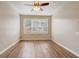 Bedroom features wood floors, neutral paint, and large bright window at 2763 Metro Sevilla Dr # 103, Orlando, FL 32835