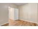 A view of a bedroom with wood-look floors and a closet with white bi-fold doors at 2763 Metro Sevilla Dr # 103, Orlando, FL 32835