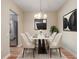 Inviting dining area with a modern table and chairs, stylish light fixture, and easy access to the kitchen at 2763 Metro Sevilla Dr # 103, Orlando, FL 32835
