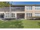 Townhouse features a screened-in patio and a lawn with landscaping at 2763 Metro Sevilla Dr # 103, Orlando, FL 32835