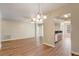 A sunlit living room and kitchen area featuring hardwood floors and a ceiling fan at 2763 Metro Sevilla Dr # 103, Orlando, FL 32835