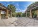 Outdoor lounging area with stone columns and pergolas, perfect for relaxing at 2763 Metro Sevilla Dr # 103, Orlando, FL 32835