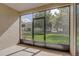 Screened-in patio offers a view of the landscaped lawn and trees at 2763 Metro Sevilla Dr # 103, Orlando, FL 32835