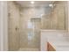 Modern shower features glass doors, custom tile, and niche for storage at 2763 Metro Sevilla Dr # 103, Orlando, FL 32835