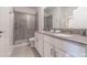 Modern bathroom featuring double sinks with gray countertops and glass-enclosed shower at 2816 Simile St, Kissimmee, FL 34746