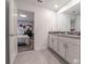 Modern bathroom featuring tile floors, double sinks, and white cabinets at 2816 Simile St, Kissimmee, FL 34746