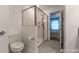 Clean bathroom with gray tile floors and glass shower enclosure at 2816 Simile St, Kissimmee, FL 34746