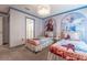 Charming bedroom with themed wall art, a statement light fixture and twin beds at 2816 Simile St, Kissimmee, FL 34746