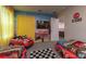 Fun themed bedroom with twin car beds, flat screen TV and racing themed wall art at 2816 Simile St, Kissimmee, FL 34746