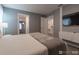 Tranquil bedroom featuring TV, neutral paint, and a view into the ensuite bathroom at 2816 Simile St, Kissimmee, FL 34746