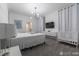 Bright bedroom features modern chandelier, TV, crib and white decor at 2816 Simile St, Kissimmee, FL 34746