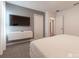 This bedroom features a TV, neutral paint, and a view into the hallway at 2816 Simile St, Kissimmee, FL 34746