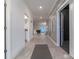 Elegant hallway with gray walls and white trim, tiled floors, and decorative wainscoting leading into home at 2816 Simile St, Kissimmee, FL 34746