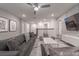 Cozy living area features a plush grey sectional sofa, modern decor and a ceiling fan, perfect for relaxation at 2816 Simile St, Kissimmee, FL 34746