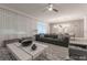 Bright living room featuring a comfortable gray sofa and contemporary furnishings at 2816 Simile St, Kissimmee, FL 34746
