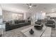 Spacious living room featuring modern gray sofa and large coffee table, open concept kitchen and dining at 2816 Simile St, Kissimmee, FL 34746
