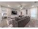 Cozy living room with modern panel accent wall, gray sofa, and plenty of seating at 2816 Simile St, Kissimmee, FL 34746