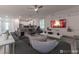 Open floor plan view of living room with kitchen in the background, featuring a stylish gray sofa at 2816 Simile St, Kissimmee, FL 34746